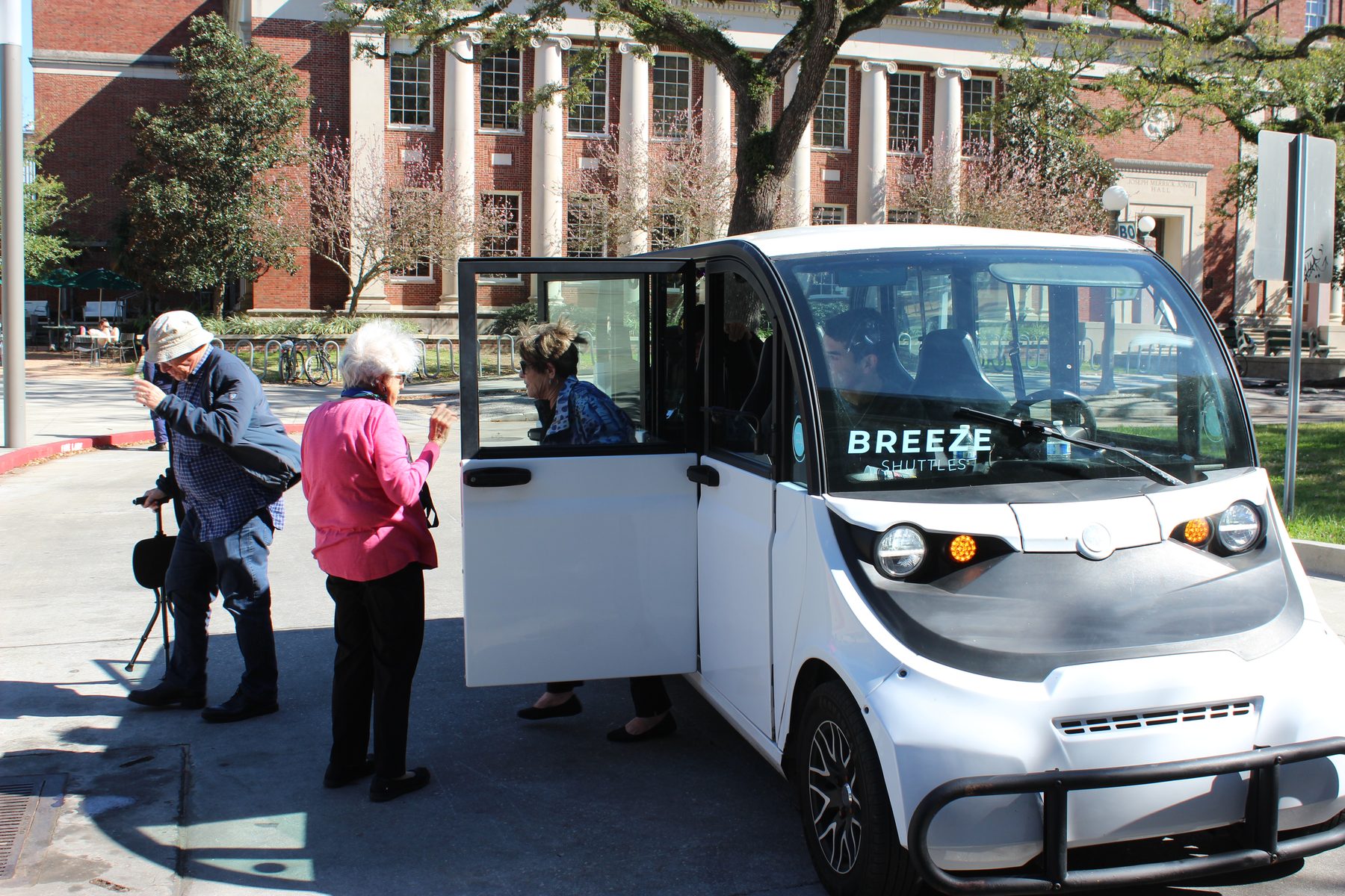Passengers boarding a Breeze shuttle on a university campus