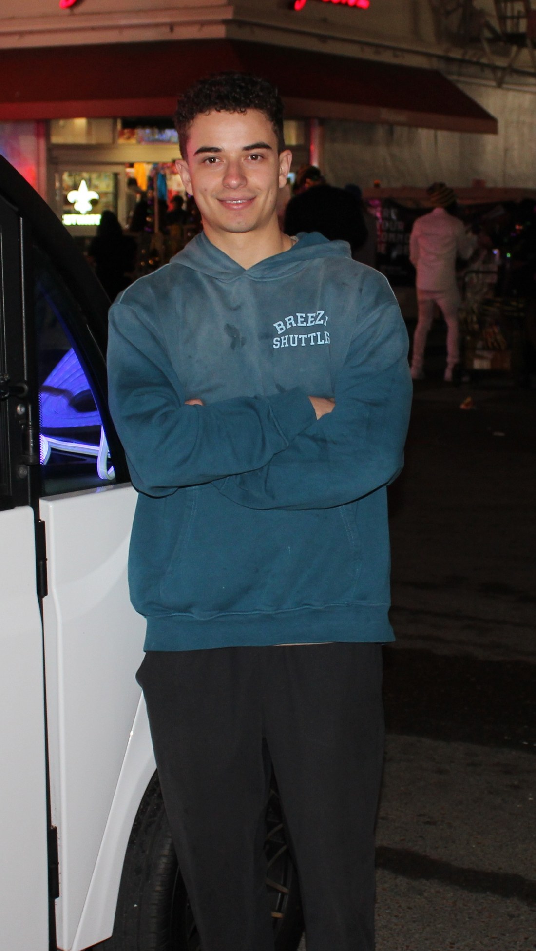 Tristan Sariego, Breeze founder, beside a shuttle in downtown New Orleans at night