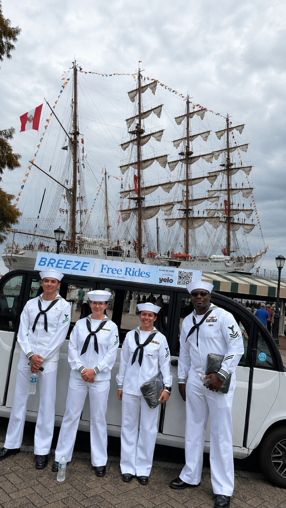 Breeze shuttle with roof sign: Free Rides, scan to ride powered by Yelo