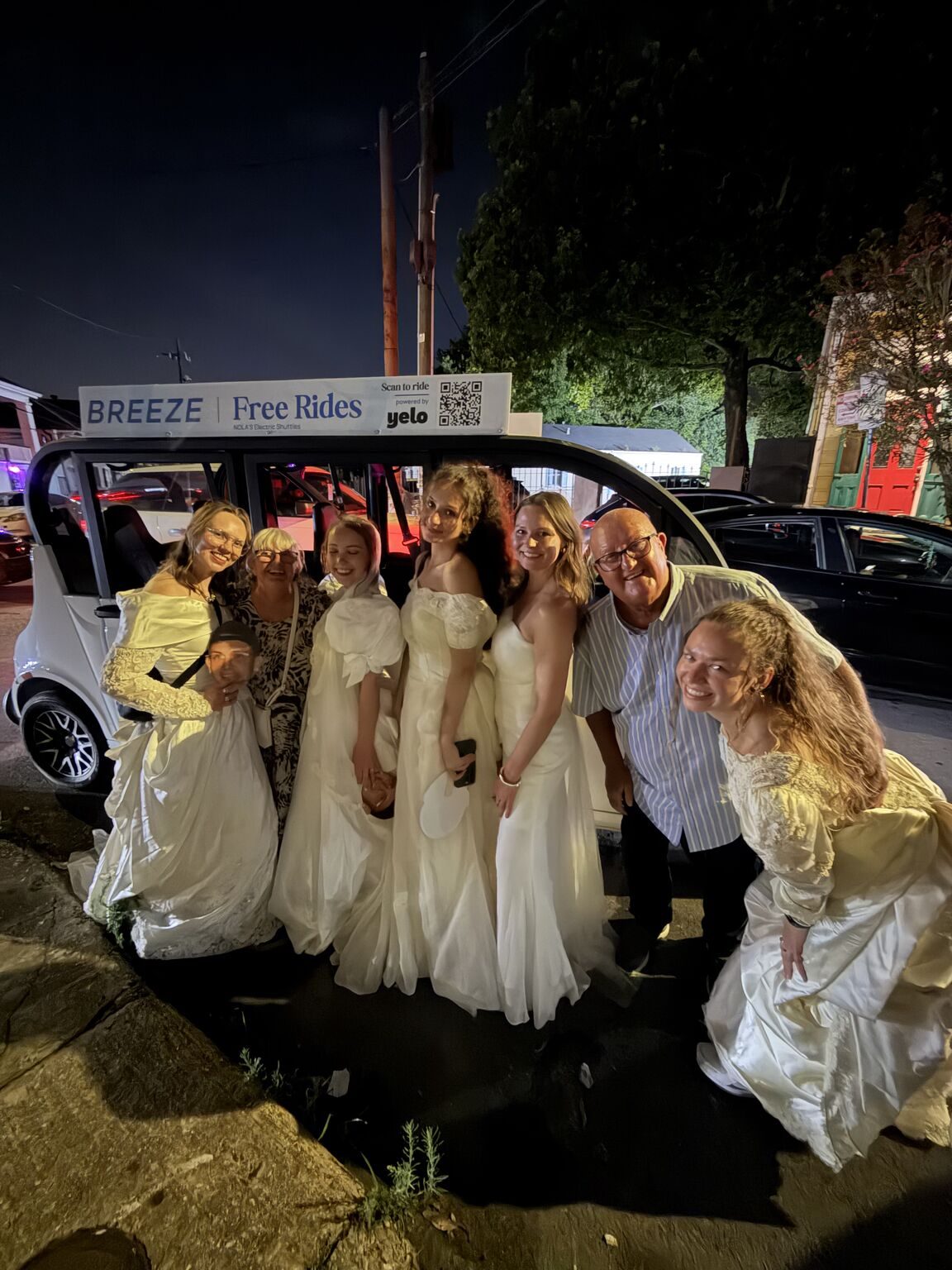Wedding party with a Breeze shuttle showing a Yelo scan-to-ride roof sign